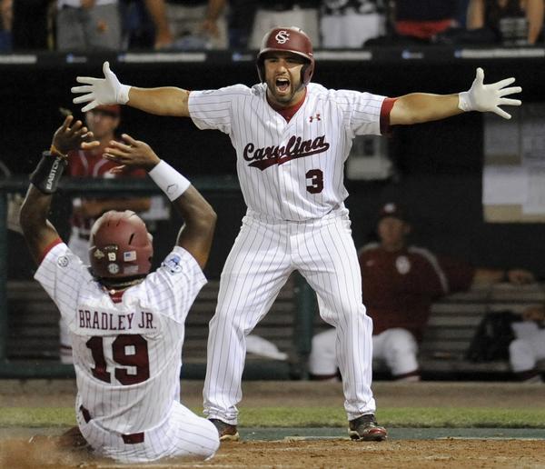 Adrian Morales greets Jackie Bradley, Jr. as he slides home with the game-winner. (Photo: Eric Francis, Associated Press)
